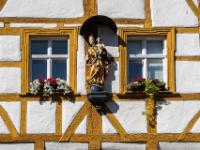 Madonnenfigur an Fachwerkhausmit Balken in Ockerfarbe - Forchheim